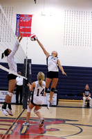 Caitlyn Stout reaches stretches to spike the ball